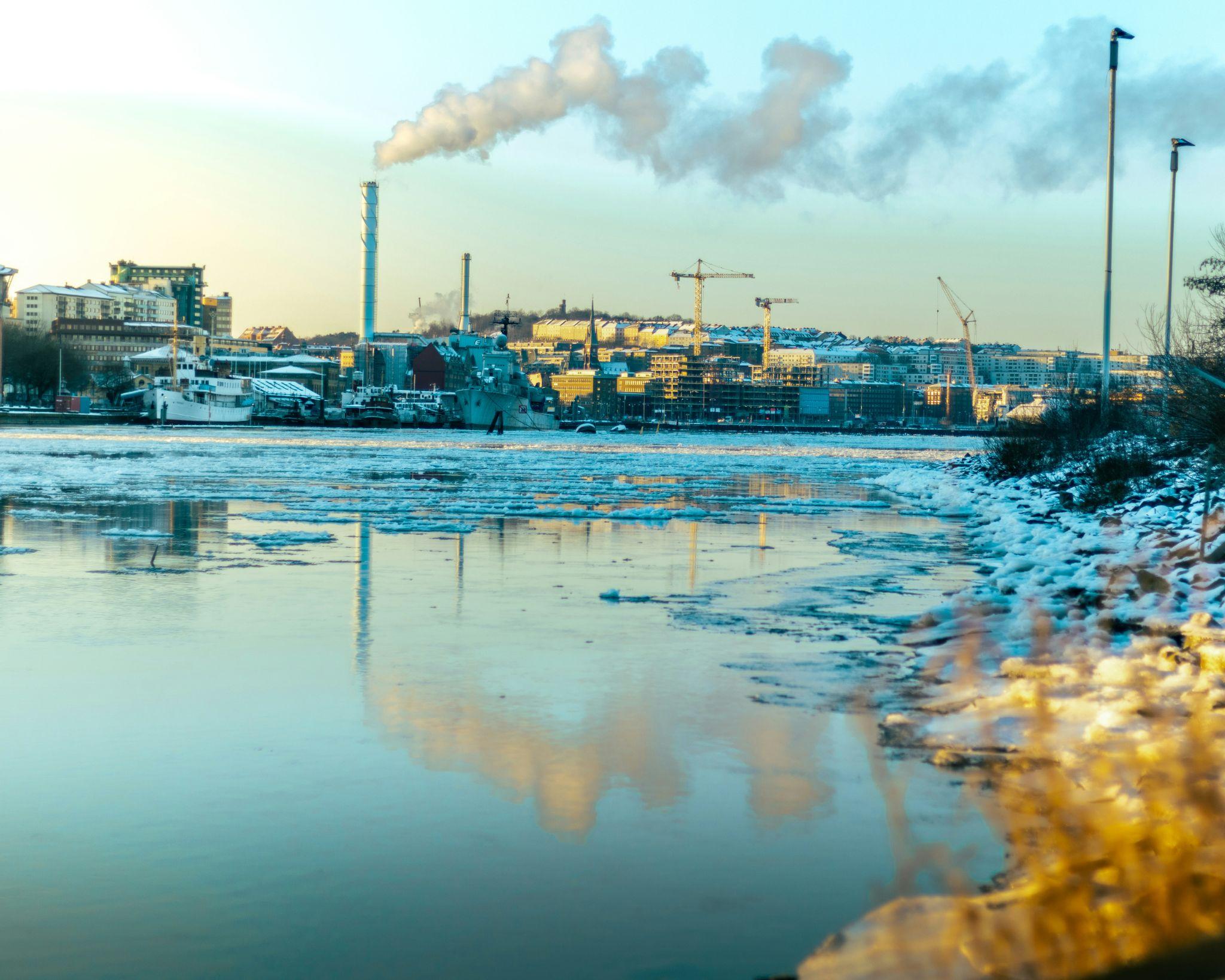 Industrial waste pipes discharging into a river, showing a key source of water pollution affecting communities and nature.