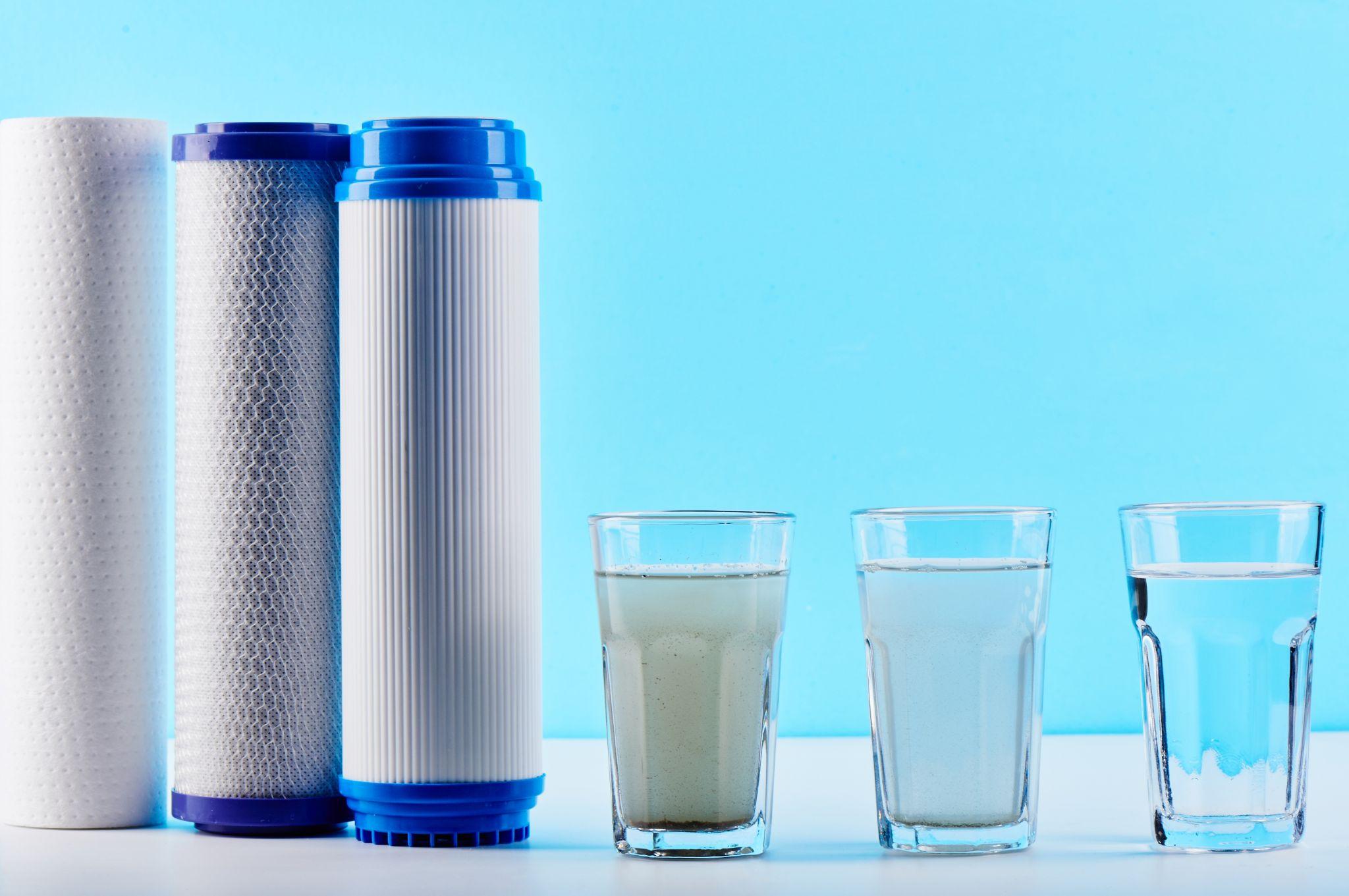 Various water filters with glasses showing different water purification stages