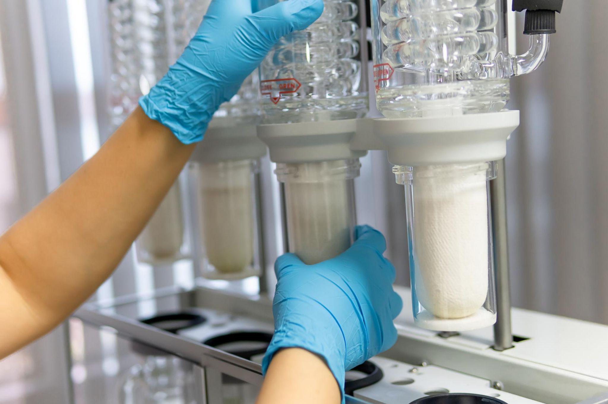 Lab technician replaces water purification filter to ensure safe drinking water