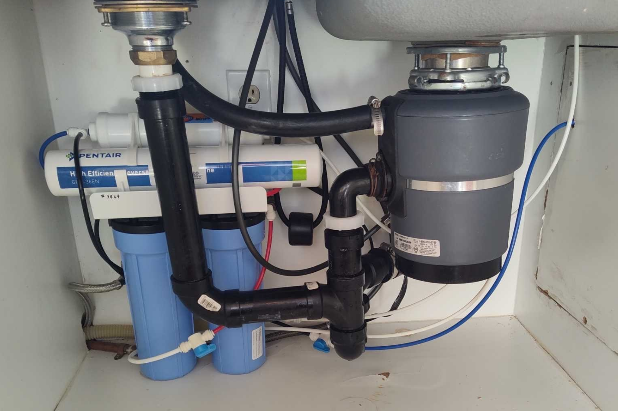 Under sink reverse osmosis filter installation with Pentair system and plumbing