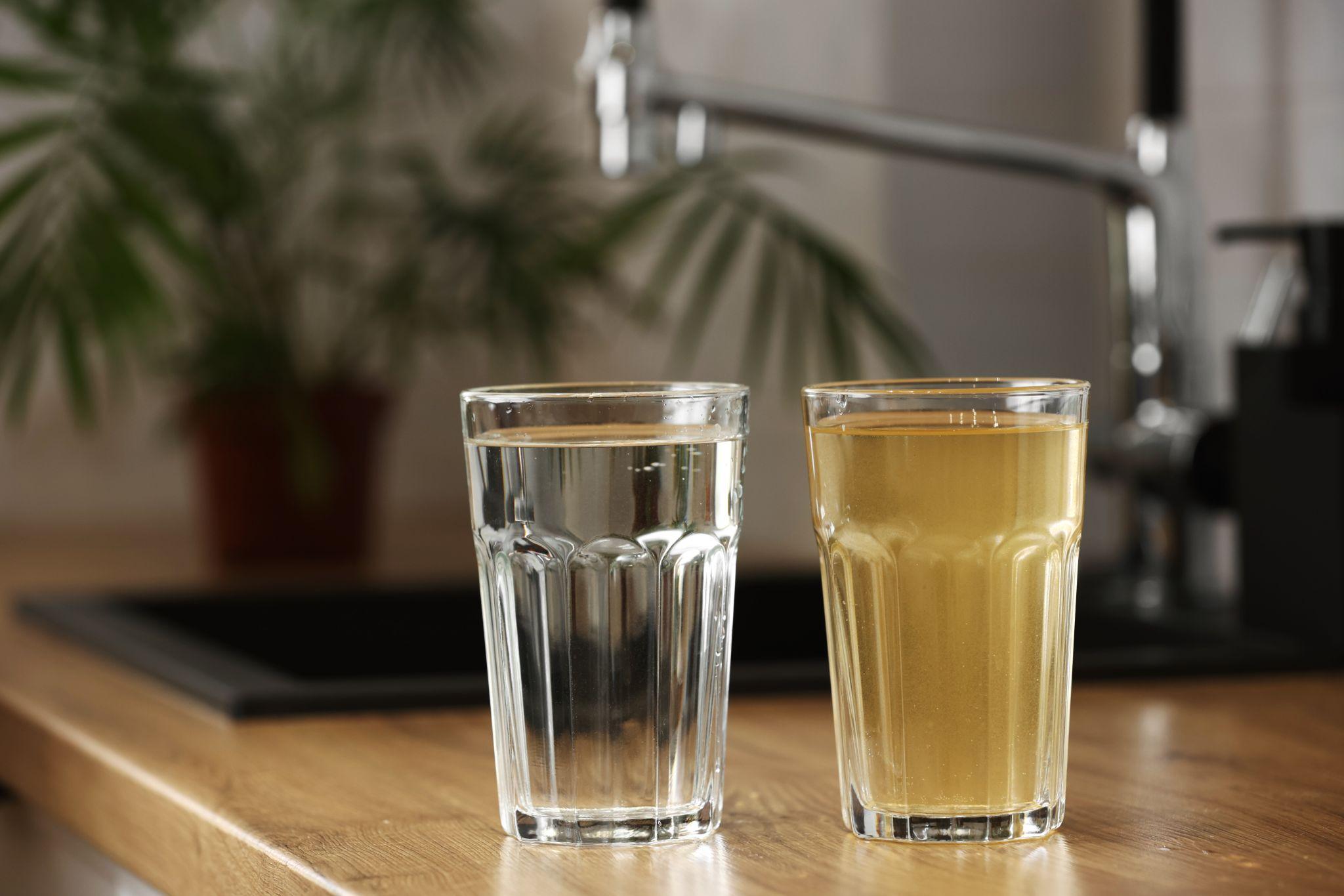 Two glasses of tap water—one clear and one discolored—highlighting the visible difference Ventura water treatment can make