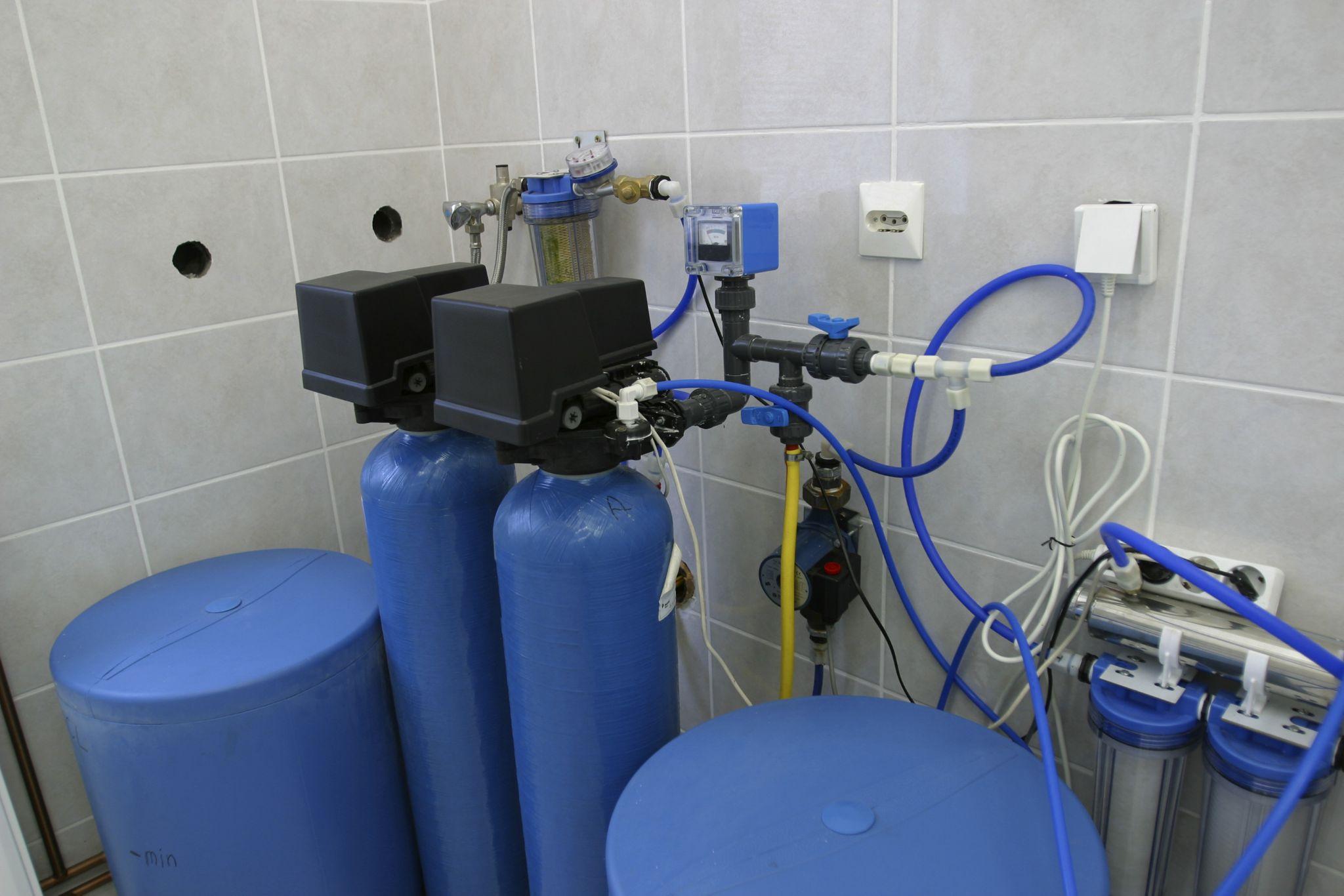 Whole-house water filtration and softener system installed in utility room, used to combat Ventura’s hard water issues