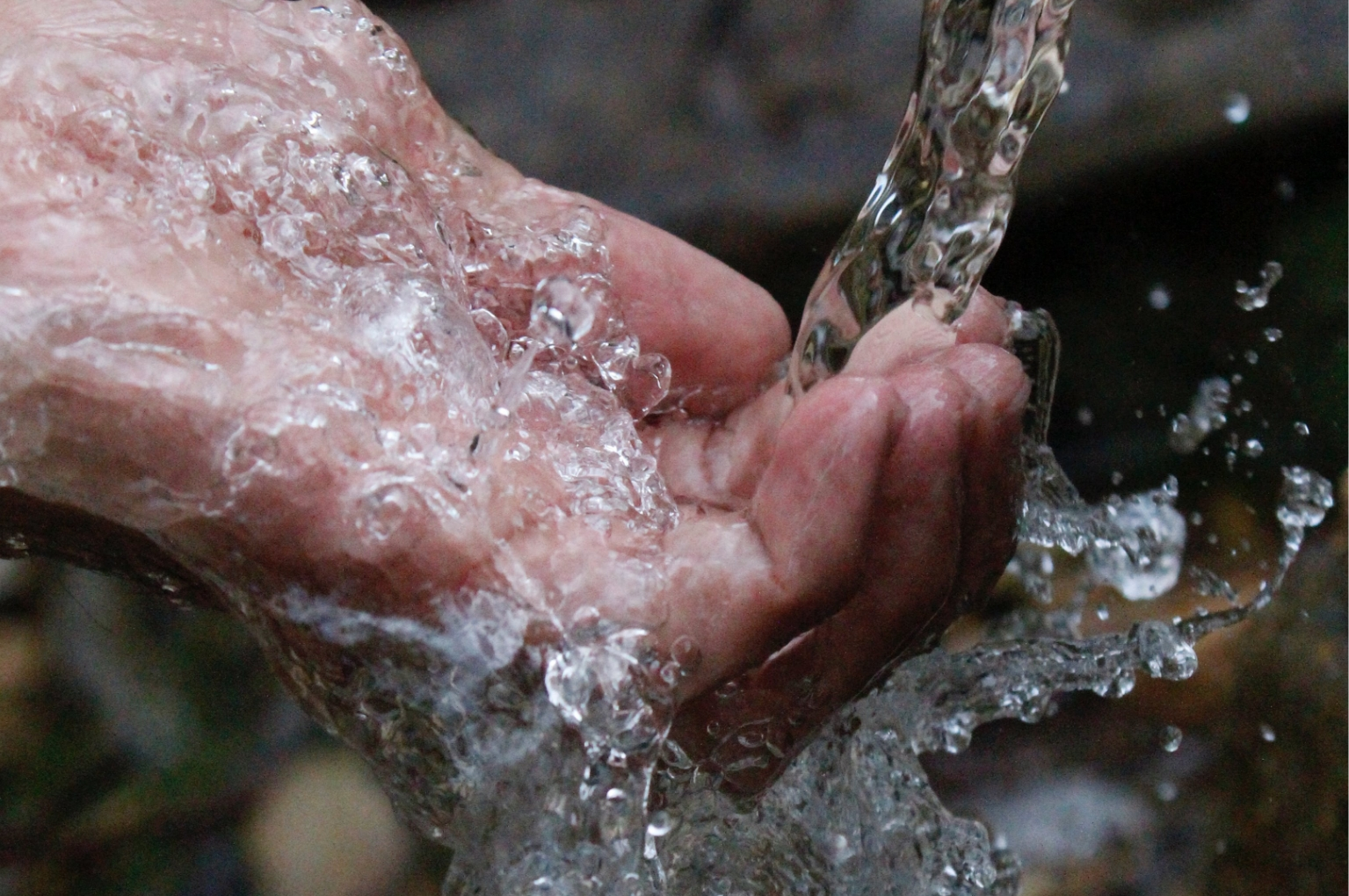 Clean running water over hands symbolizing sustainable bottleless water dispenser