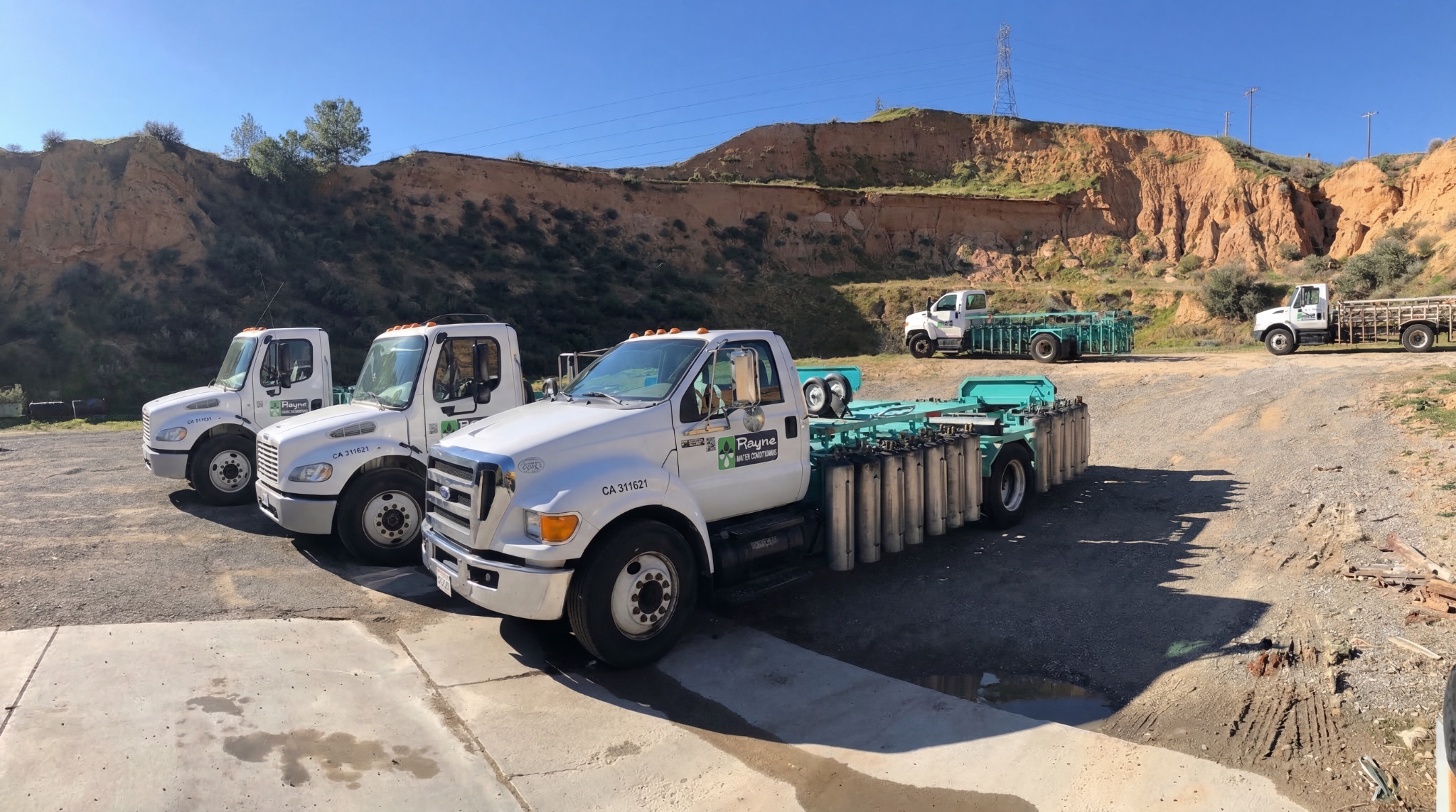 Rayne Water service trucks loaded with portable exchange tanks for delivery